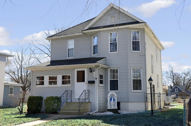 traditional-style house featuring fence