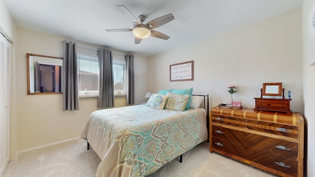 bedroom featuring a closet, baseboards, carpet, and a ceiling fan