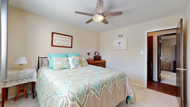 carpeted bedroom featuring visible vents, a ceiling fan, and baseboards