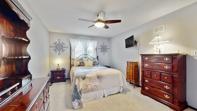 carpeted bedroom featuring visible vents and ceiling fan