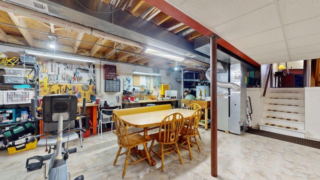 dining space with stairs and concrete floors