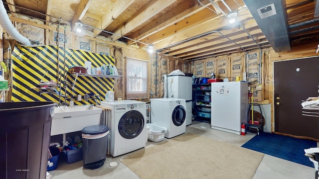 laundry room with laundry area, washer and dryer, visible vents, and a sink