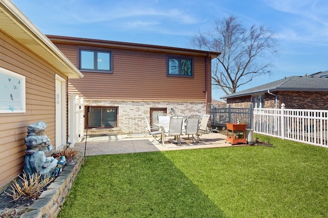 back of house featuring a patio area, a lawn, and fence