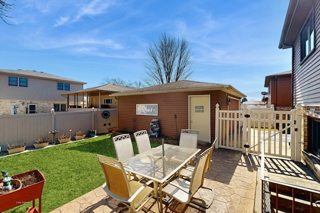 view of patio featuring outdoor dining area, a vegetable garden, and fence