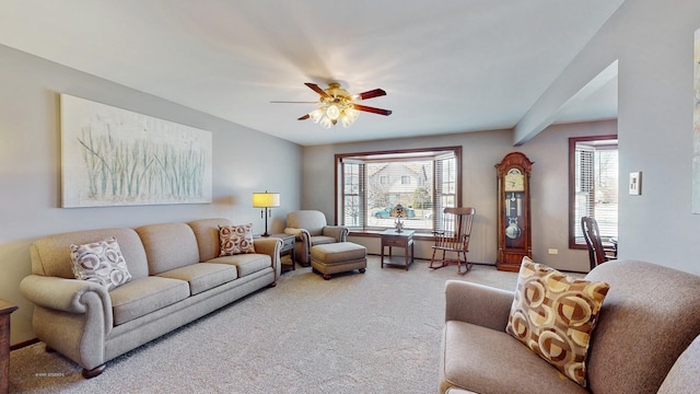 living area with carpet flooring and ceiling fan