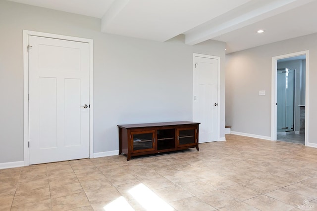 spare room with recessed lighting, baseboards, beam ceiling, and light tile patterned floors