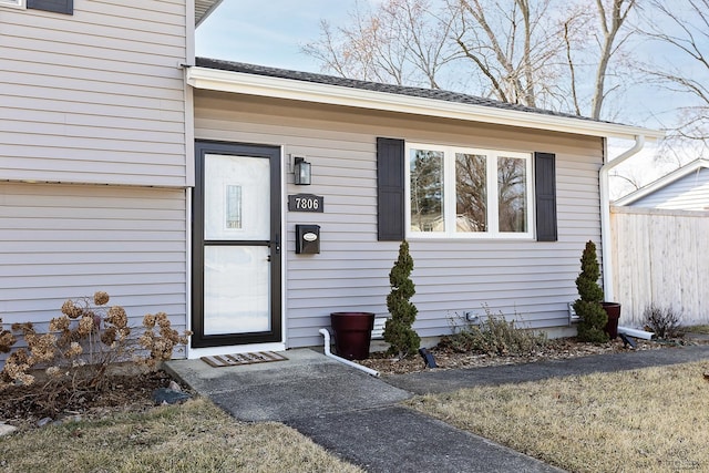 view of exterior entry with fence