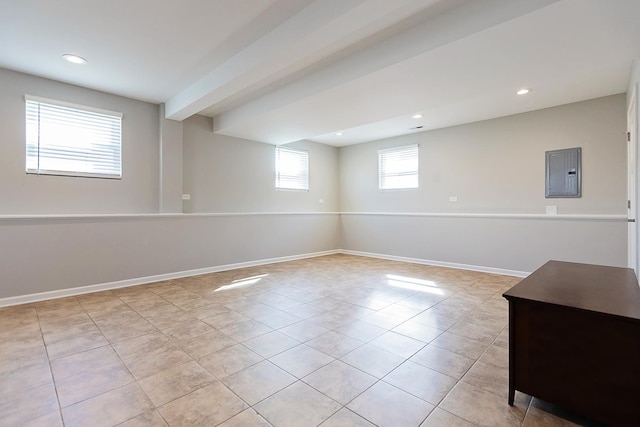 below grade area with electric panel, recessed lighting, baseboards, and light tile patterned flooring