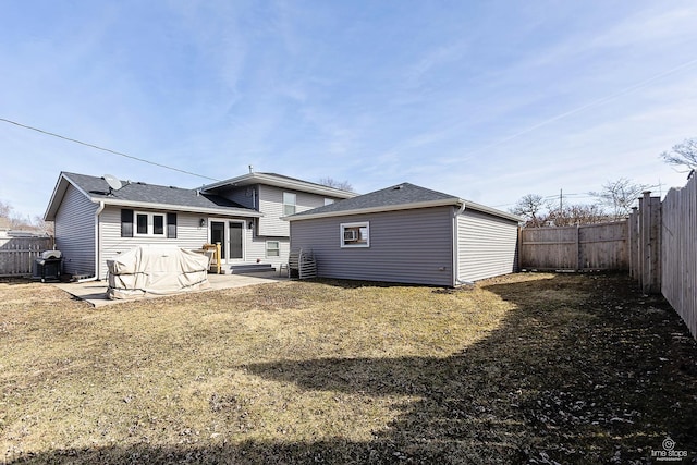 back of house with a yard, a patio, and a fenced backyard