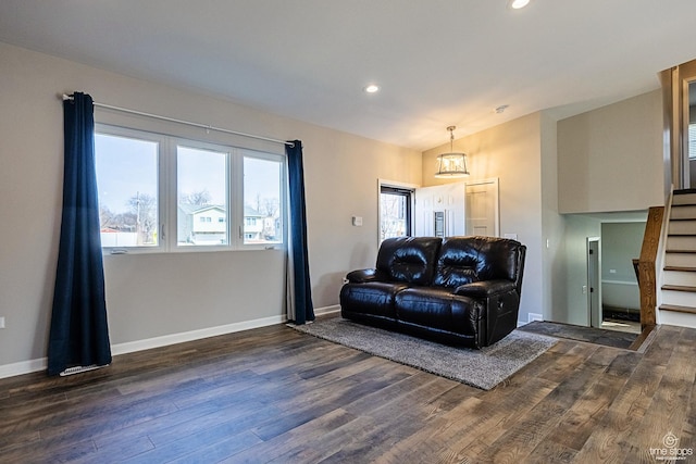 living area with recessed lighting, stairway, baseboards, and dark wood finished floors