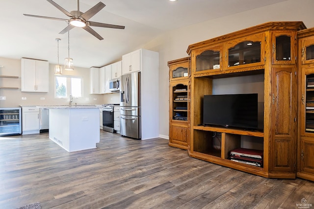 kitchen featuring a kitchen island, dark wood finished floors, stainless steel appliances, wine cooler, and vaulted ceiling