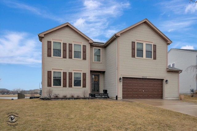 traditional-style house with a front yard, an attached garage, and driveway