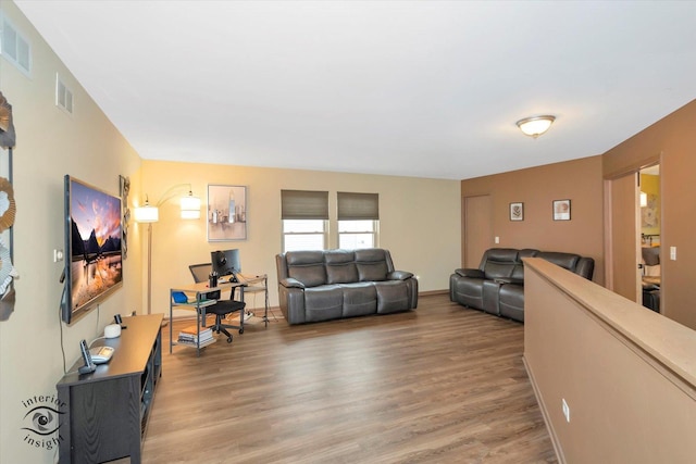 living room with light wood-type flooring and visible vents