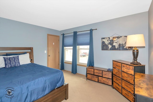 bedroom with baseboards and carpet