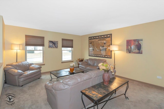 carpeted living room with baseboards