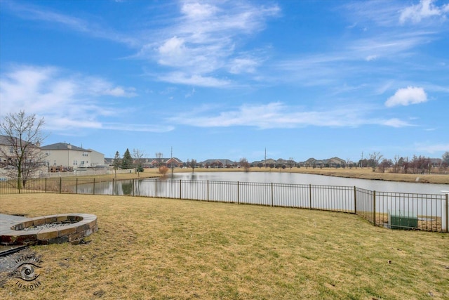 view of yard with fence and a water view