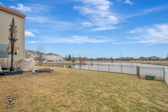 view of yard with a water view and fence