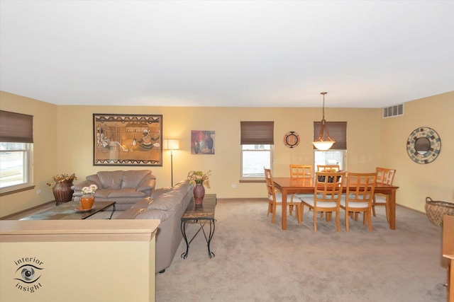 living room featuring visible vents and light colored carpet