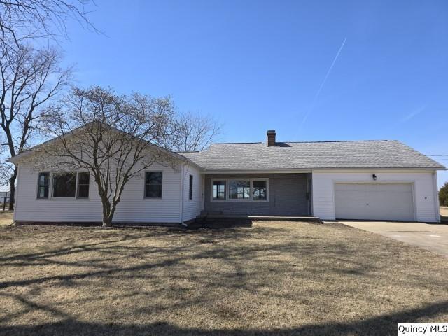 single story home featuring a front lawn, an attached garage, driveway, and roof with shingles