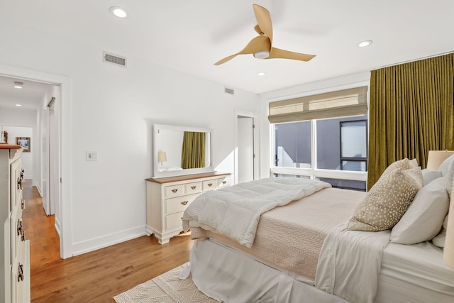 bedroom featuring light wood finished floors, visible vents, and recessed lighting