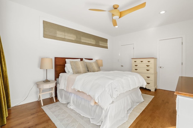 bedroom featuring recessed lighting, wood finished floors, baseboards, and ceiling fan