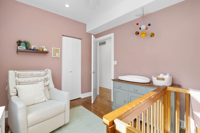 bedroom with visible vents, wood finished floors, recessed lighting, a closet, and baseboards