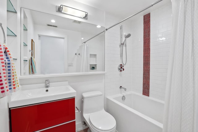 bathroom featuring vanity, shower / tub combo, toilet, and visible vents