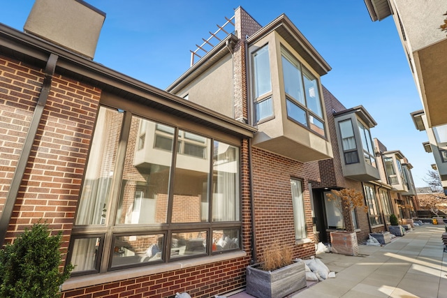 view of side of property featuring brick siding