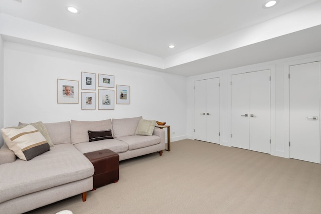 living area featuring recessed lighting, baseboards, and light carpet