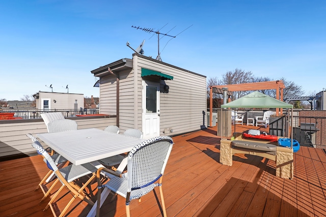 wooden terrace featuring outdoor dining area