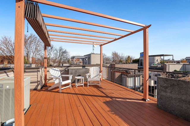 wooden terrace with central AC unit and a pergola