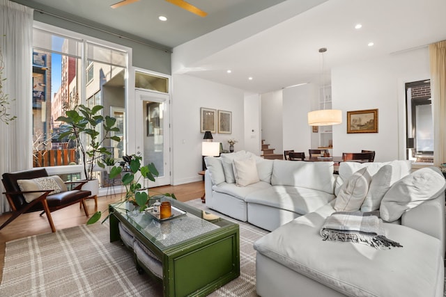 living room with recessed lighting, baseboards, ceiling fan, and wood finished floors