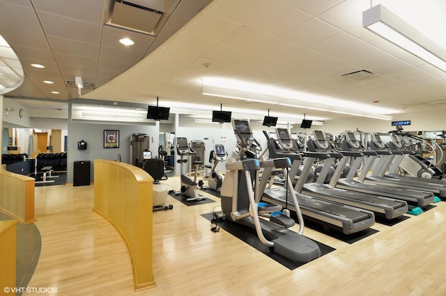 exercise room featuring visible vents and wood finished floors