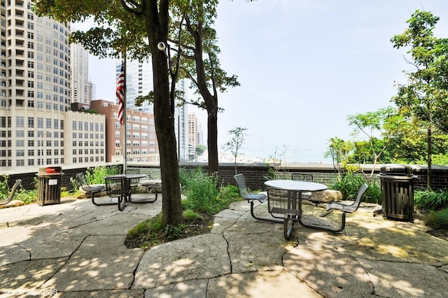 view of patio with a city view and outdoor dining space