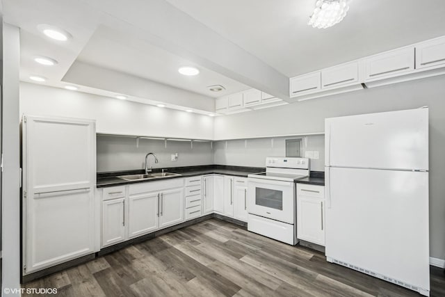 kitchen featuring dark countertops, white appliances, open shelves, and a sink