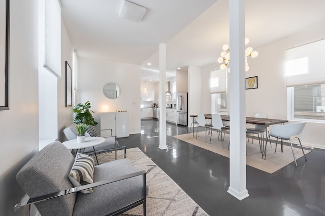 living area with ornate columns, recessed lighting, and baseboards