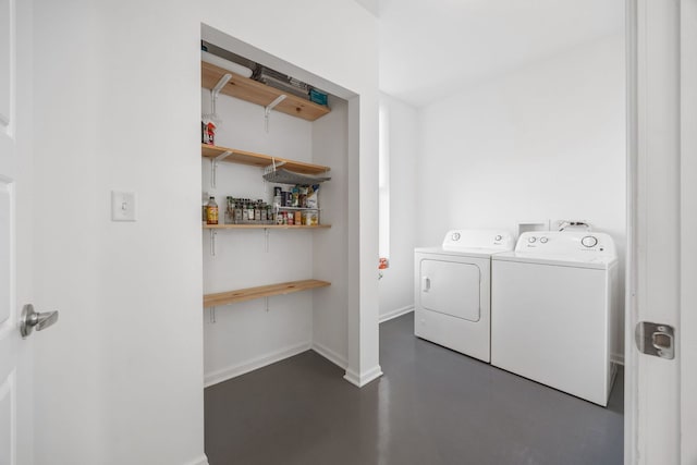 laundry area with baseboards, a bar, laundry area, and washer and clothes dryer