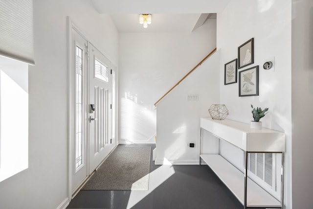 entrance foyer featuring stairway, baseboards, and visible vents