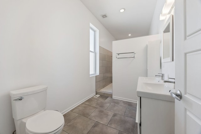 full bathroom featuring visible vents, double vanity, a walk in shower, tile patterned floors, and toilet