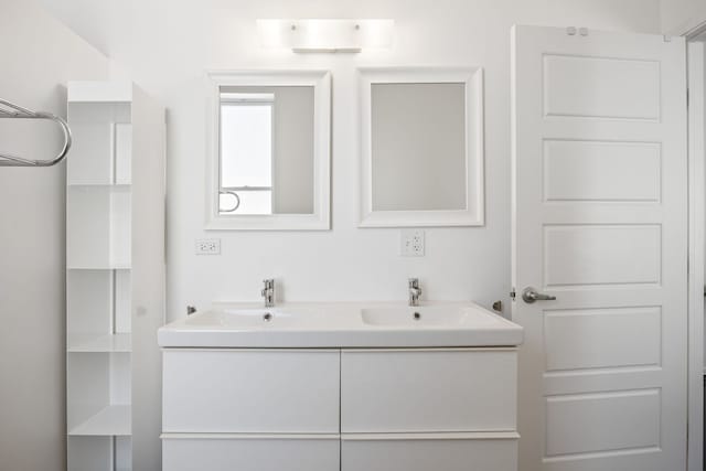 bathroom with a sink and double vanity