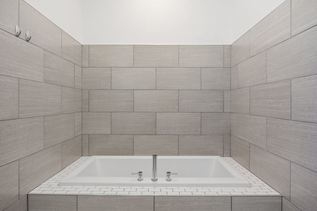 full bathroom with tiled bath