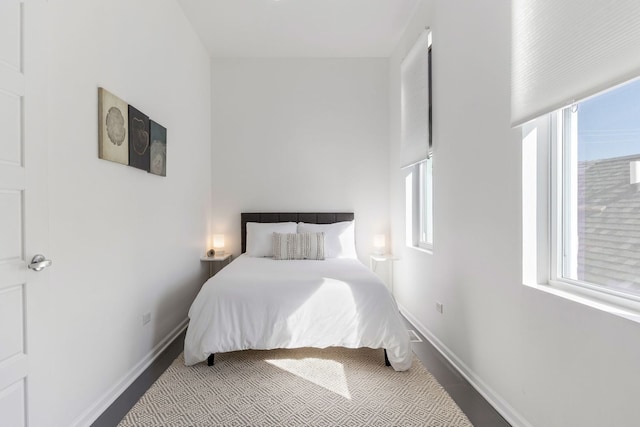 bedroom featuring multiple windows and baseboards