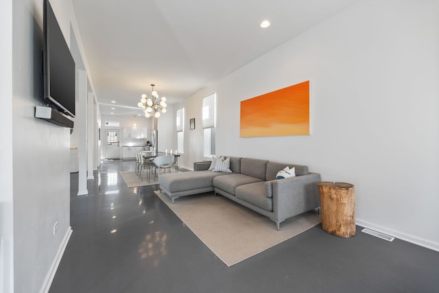 living area featuring a notable chandelier, recessed lighting, visible vents, and finished concrete floors