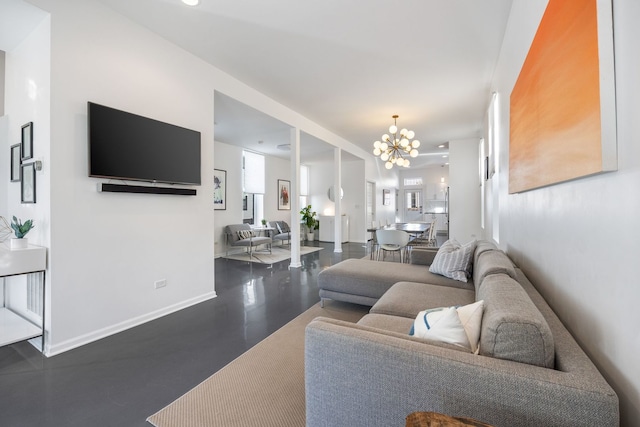 living room with baseboards, plenty of natural light, and a chandelier