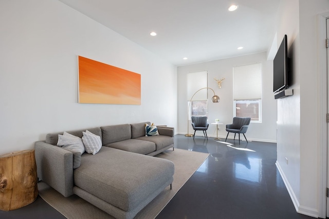 living room featuring recessed lighting, concrete flooring, and baseboards