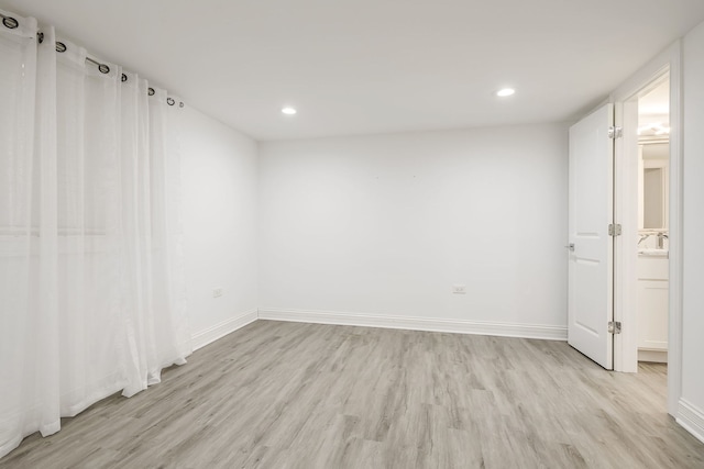 unfurnished room featuring recessed lighting, baseboards, and light wood-style flooring