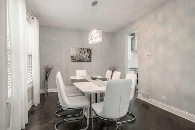 dining space with visible vents, dark wood-type flooring, and baseboards