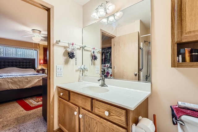 full bath featuring toilet, vanity, ensuite bathroom, and ceiling fan