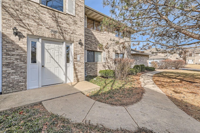 entrance to property with brick siding