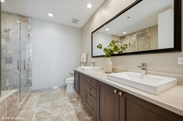 full bathroom featuring visible vents, a stall shower, toilet, and a sink